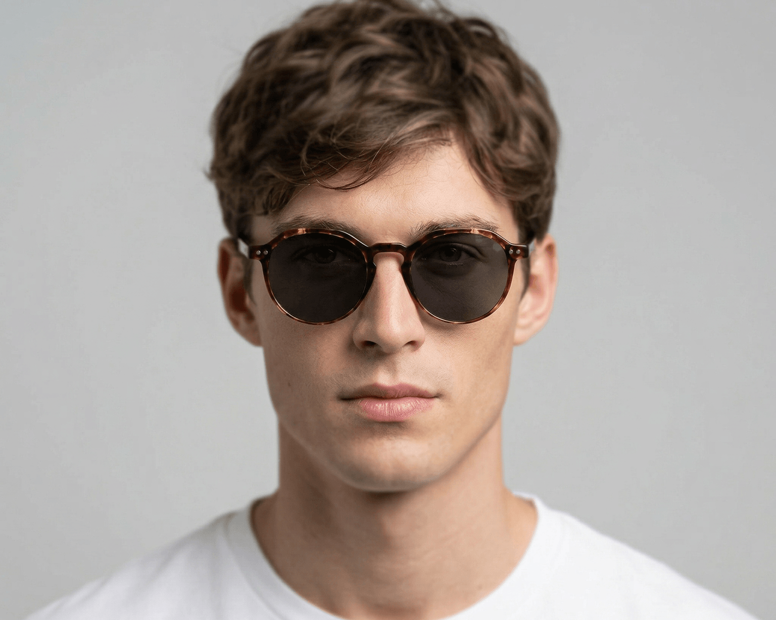 Man wearing sunglasses with a plain background Tortoiseshell