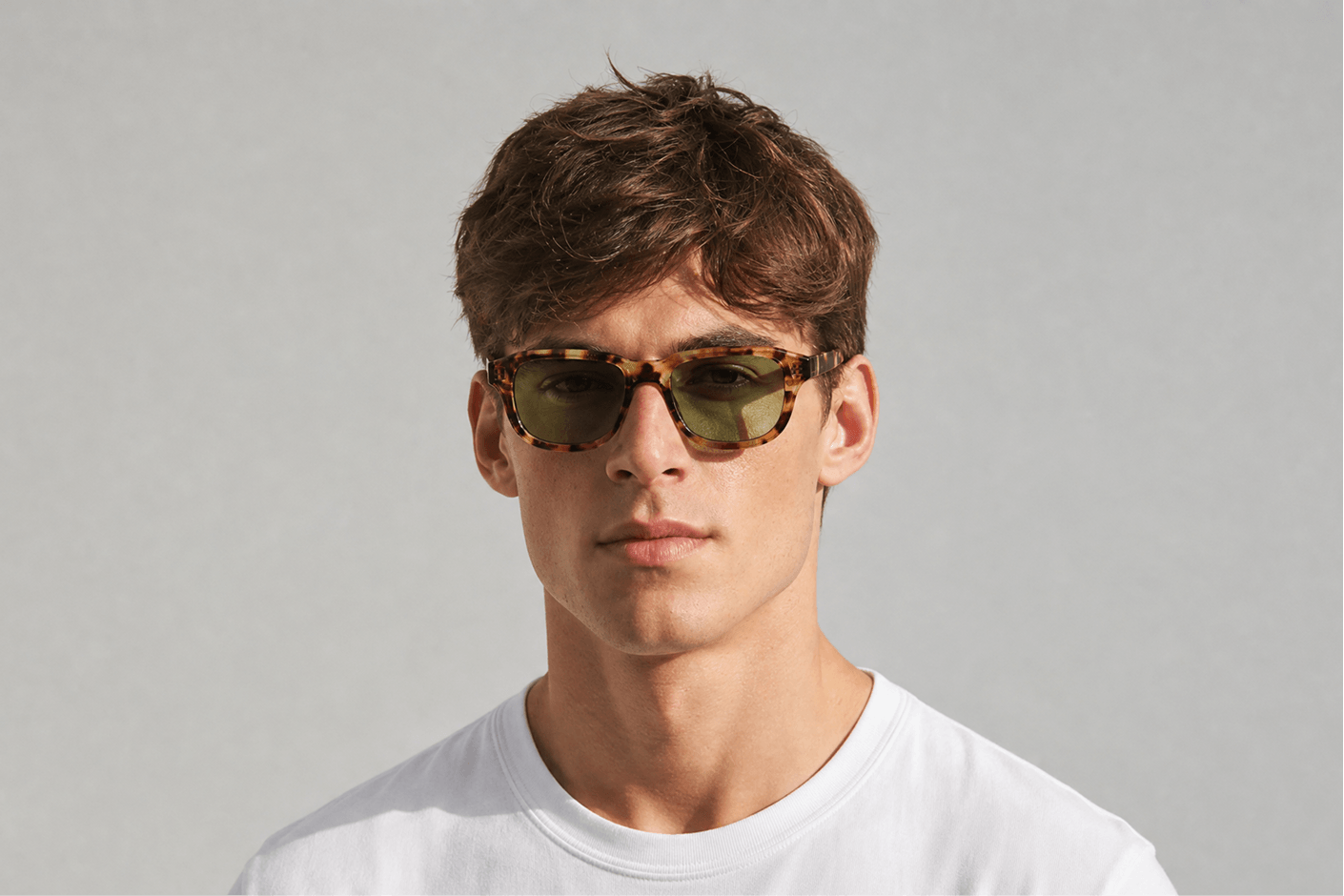 Man wearing sunglasses with a plain gray background Tortoiseshell leo