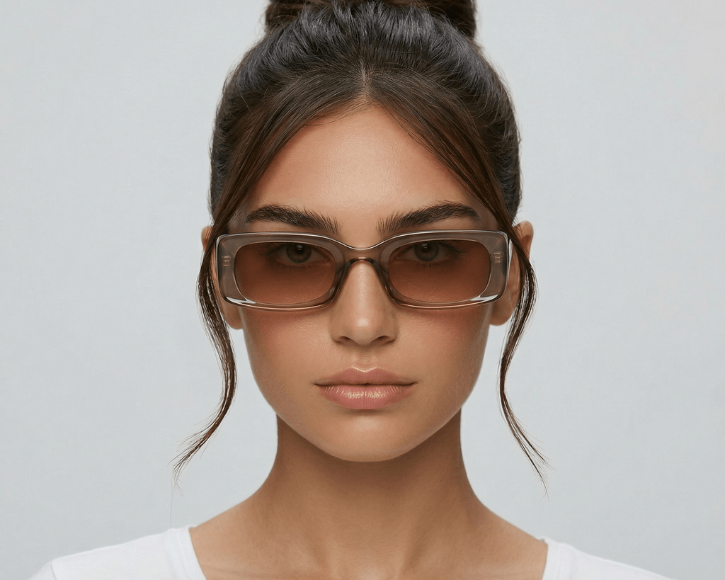 Woman wearing sunglasses with a plain background Clear brown