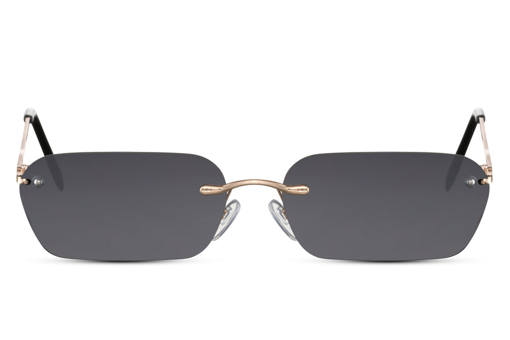 Sunglasses with gold frame and dark lenses on a white background