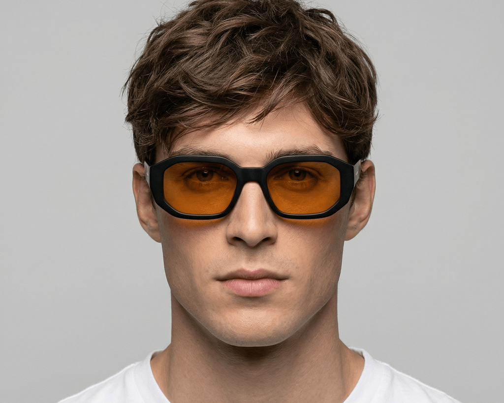 Man wearing Shadow yellow sunglasses with orange lenses against a gray background Shadow yellow