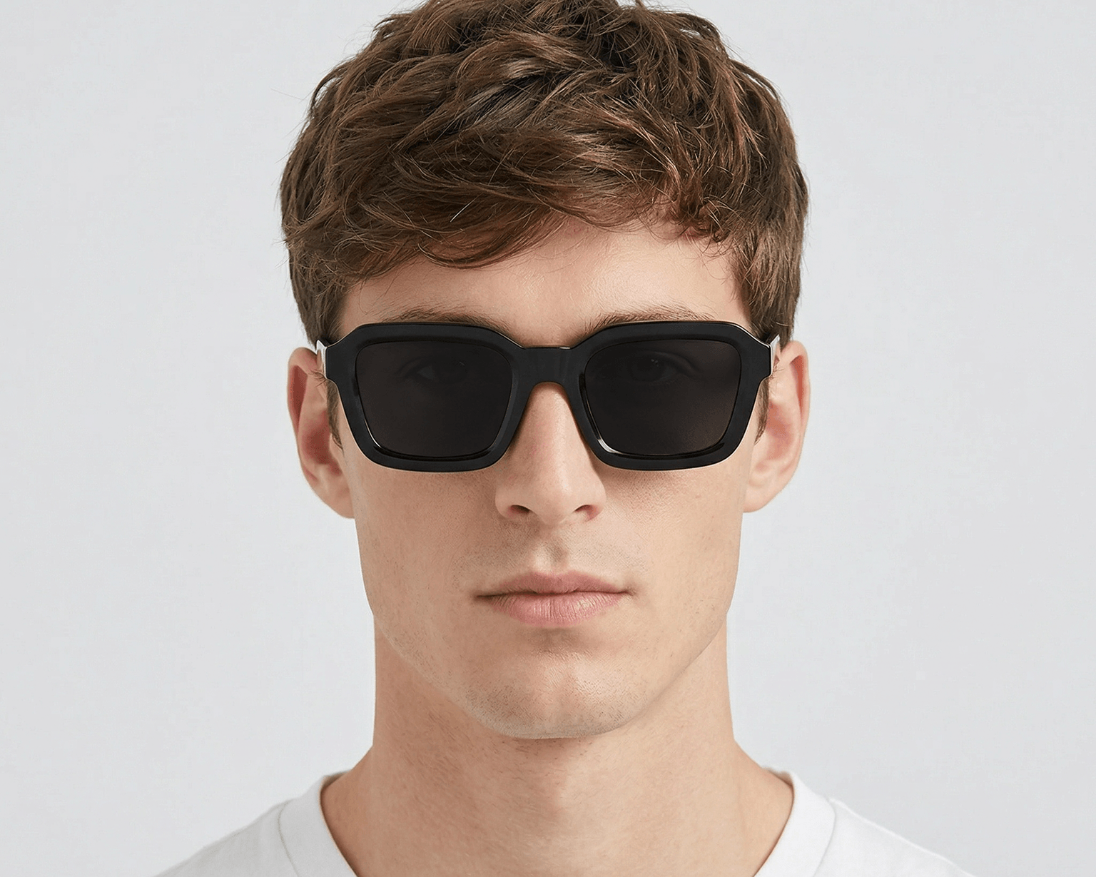 Man wearing black sunglasses against a white background Black