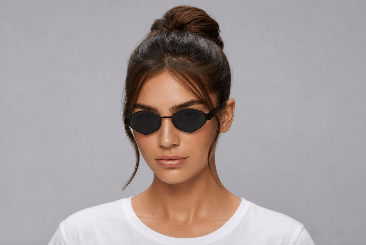 Woman wearing black sunglasses with a gray background Black