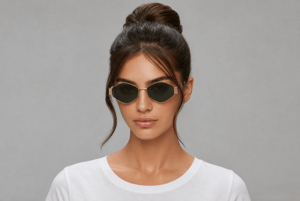 Woman wearing sunglasses with a gray background gold/green