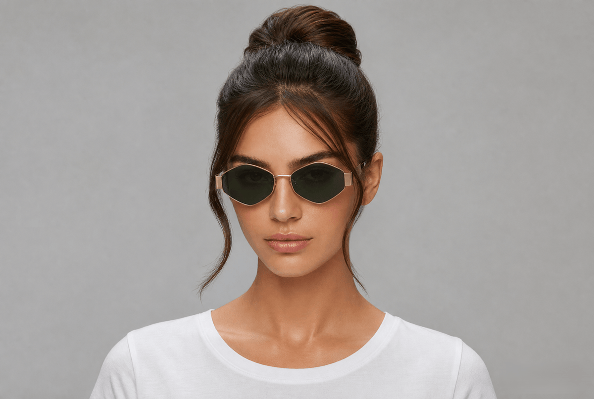 Woman wearing sunglasses with a gray background gold/green