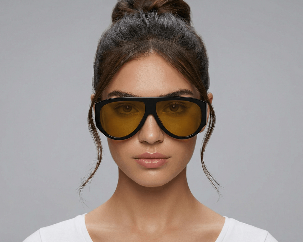 Woman wearing large sunglasses with a gray background