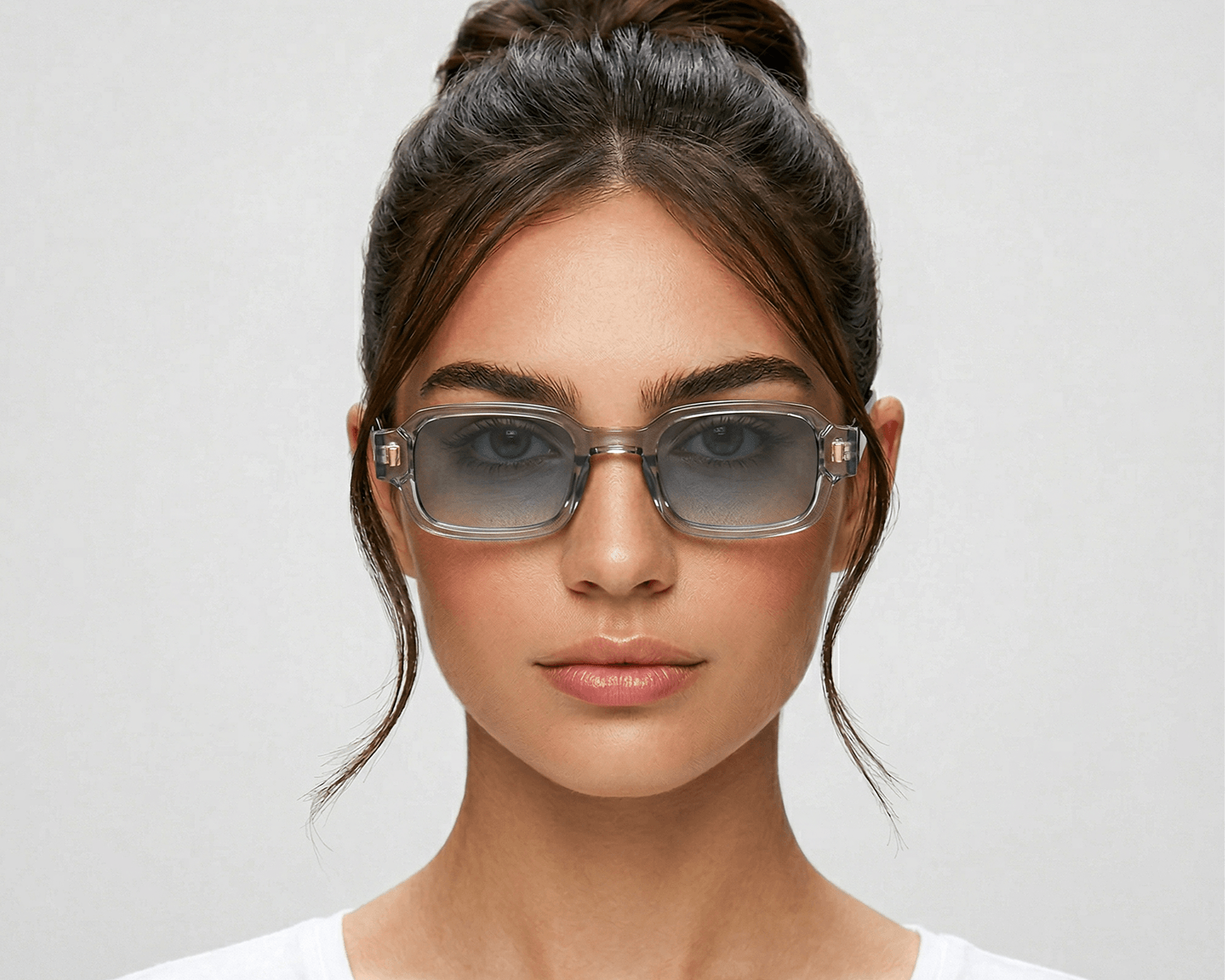 Woman wearing glasses with a plain background Clear blue