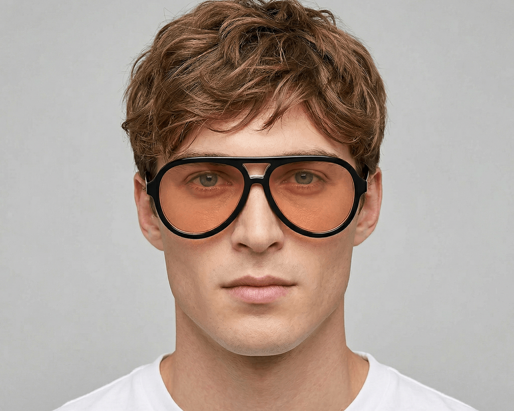 Person wearing large black-framed sunglasses with a plain background