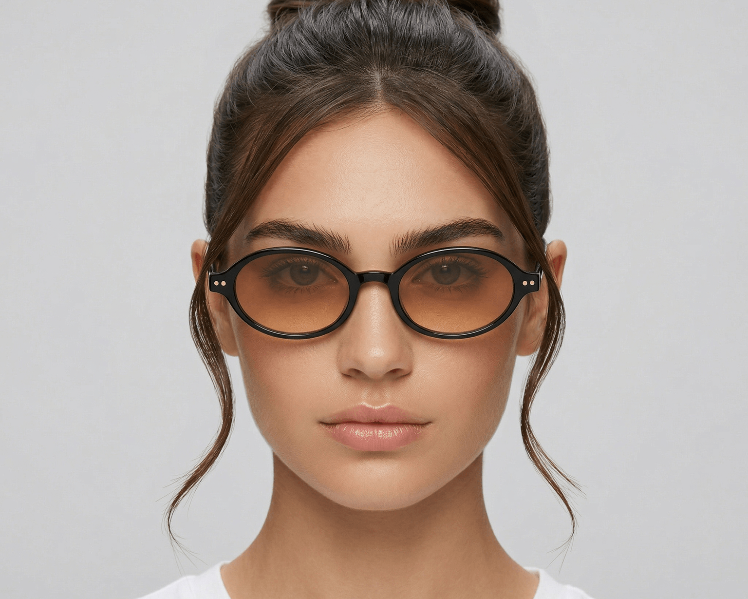 Woman wearing glasses with a plain background