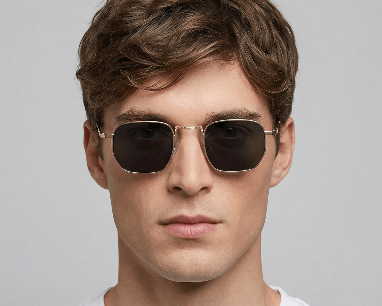 Man wearing sunglasses with a plain background Black
