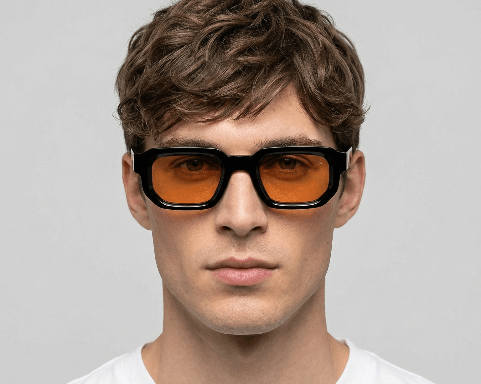 Man wearing sunglasses with a plain background Orange