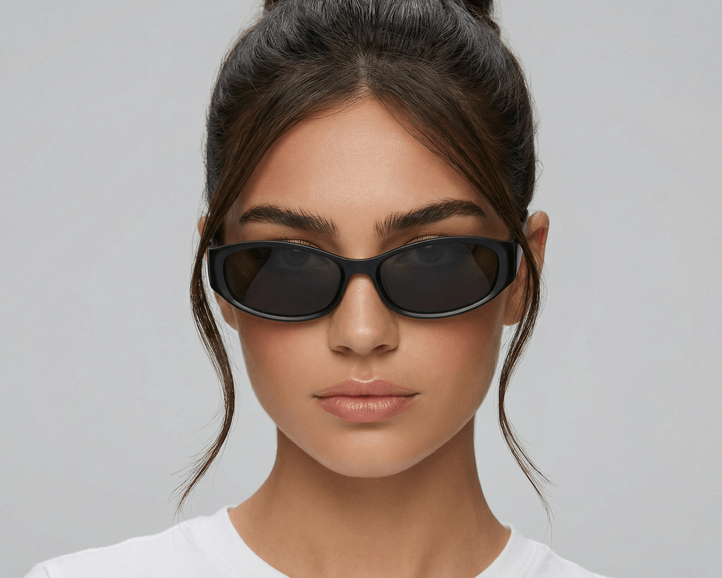 Woman wearing black sunglasses with a plain background