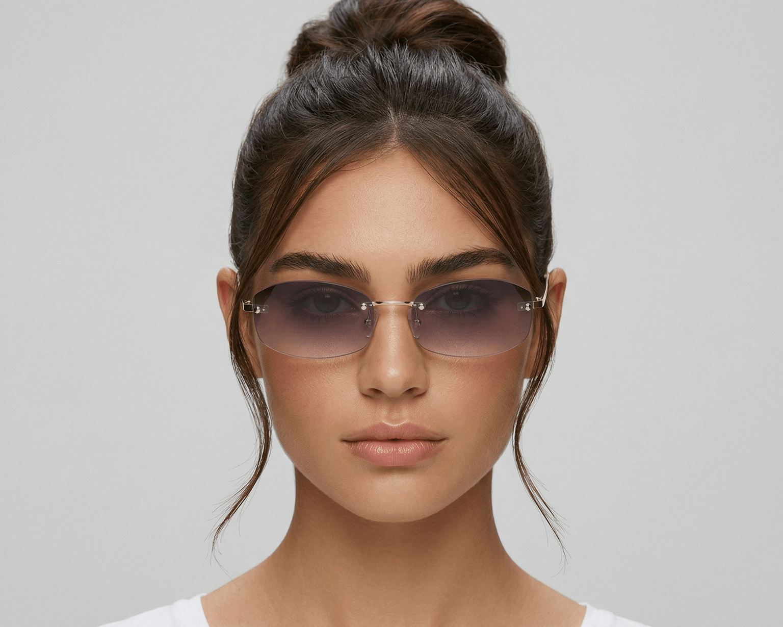 Woman wearing sunglasses with a plain background