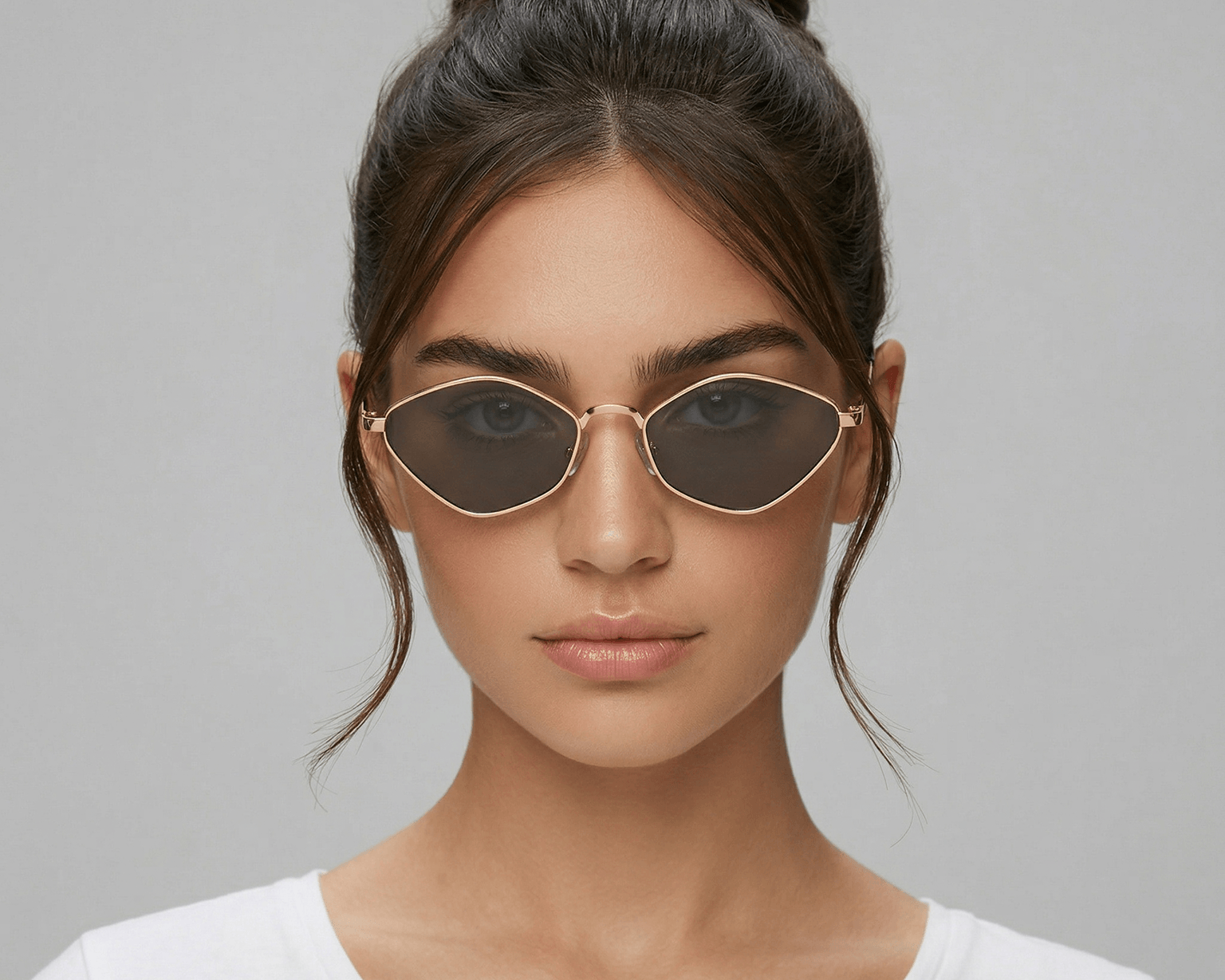Woman wearing sunglasses with a plain background Black