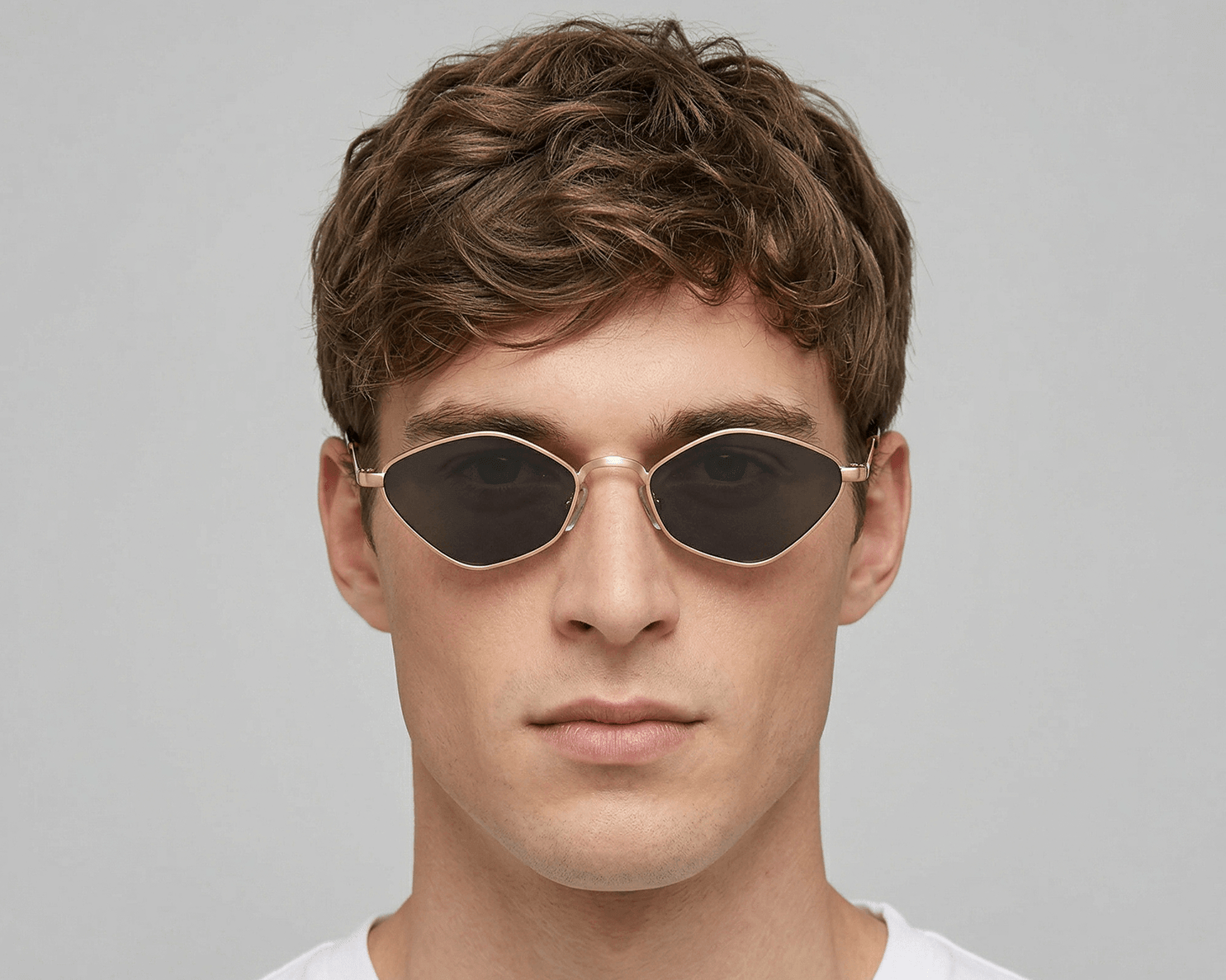 Man wearing sunglasses with a plain background Black