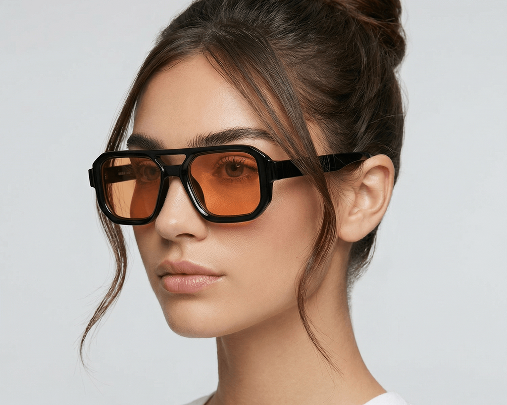 Woman wearing large sunglasses with a plain background Orange